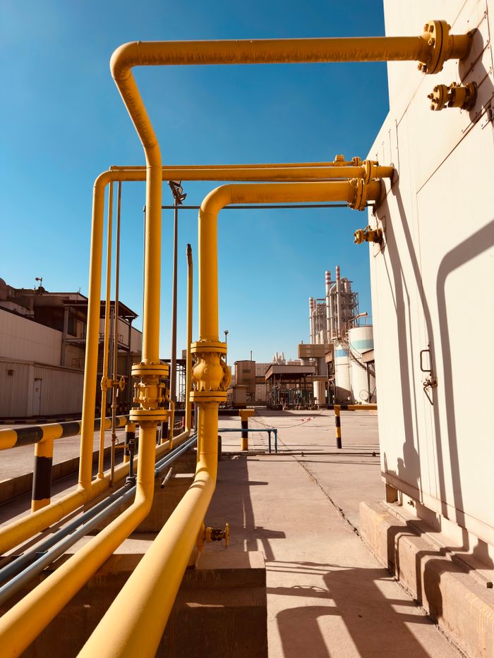 Mastering the First Impression: Your intriguing post title goes here Yellow gas pipeline with clear blue sky at a Saudi cement factory.